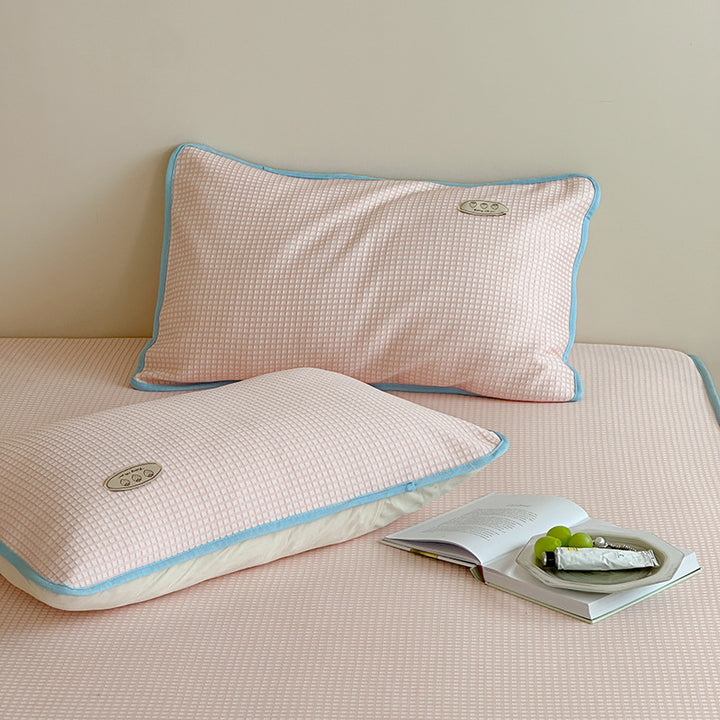 Cooling waffle structure pillow with breathable filling core and decorative piping