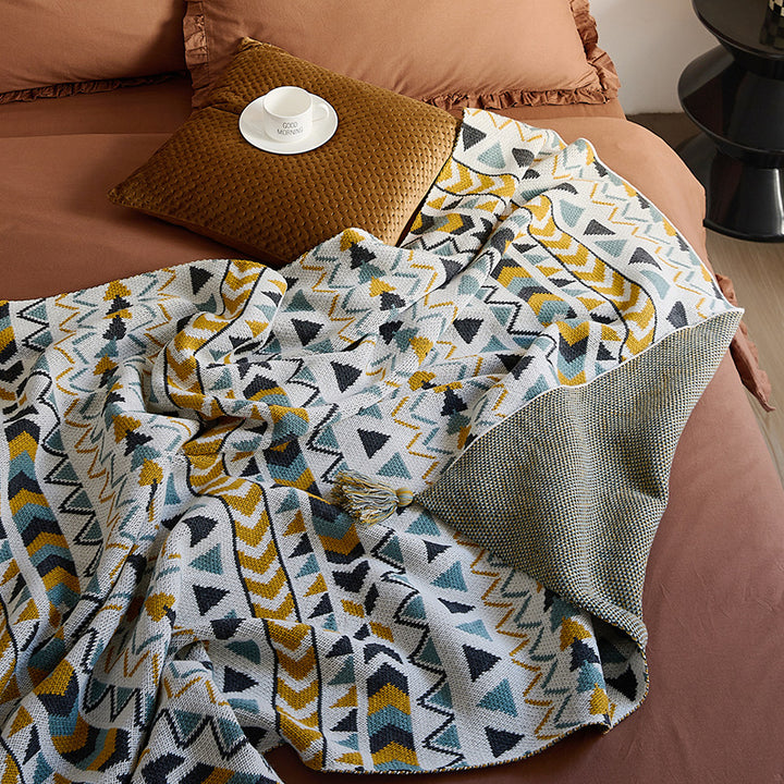 Patterned throw blanket in ethnic knit design with tassels