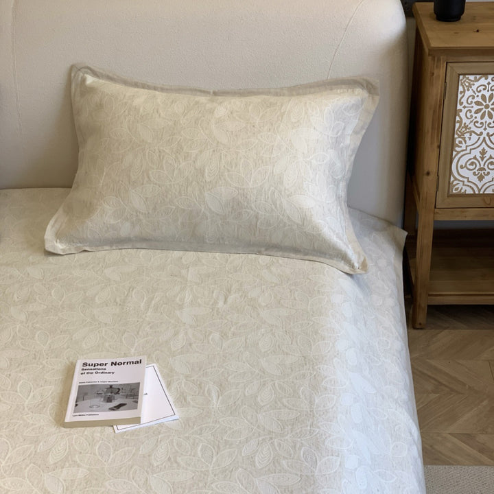 Jacquard cushion cover with quilted diamond pattern and piping
