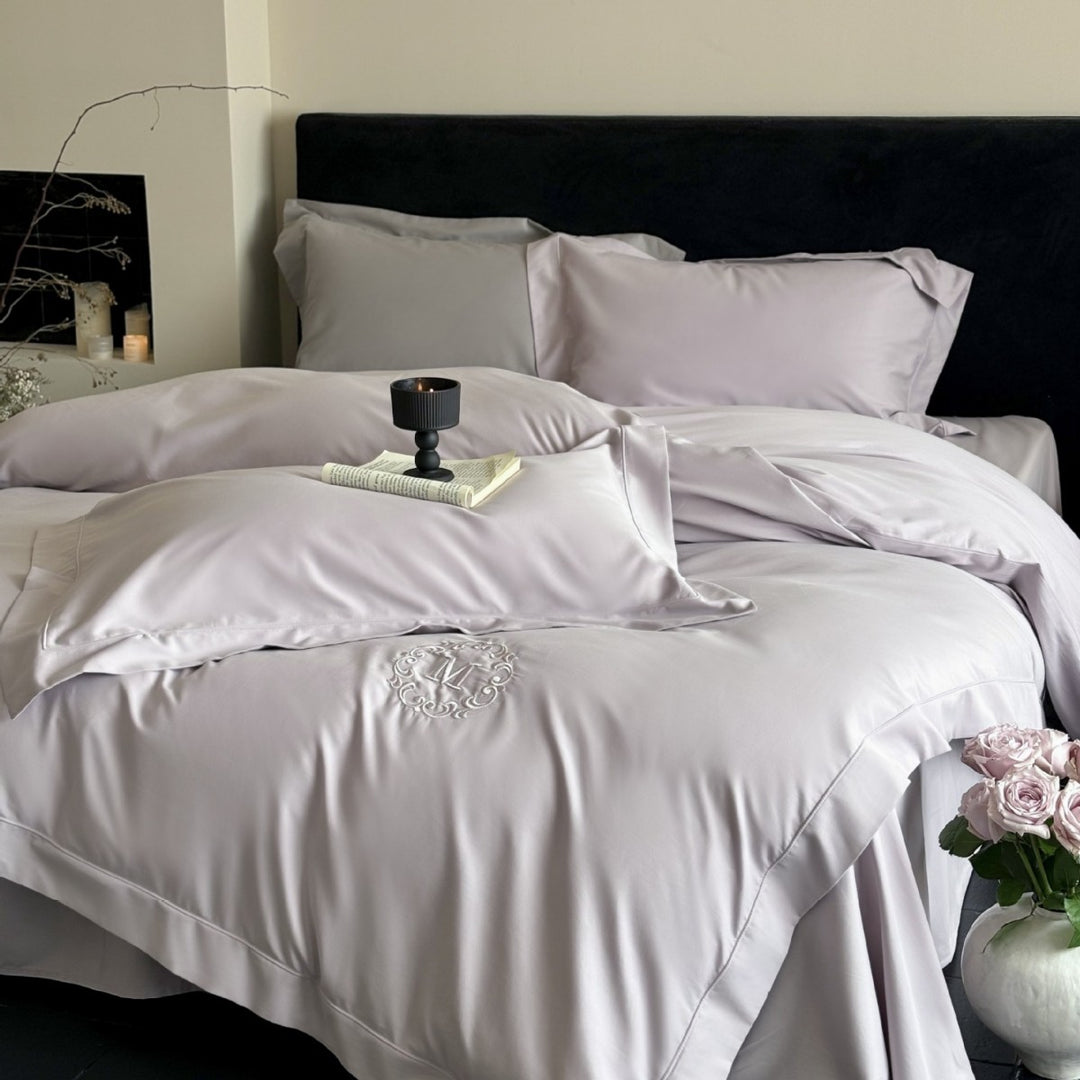 Luxurious cotton satin bedding set with monogram embroidery and fine piping