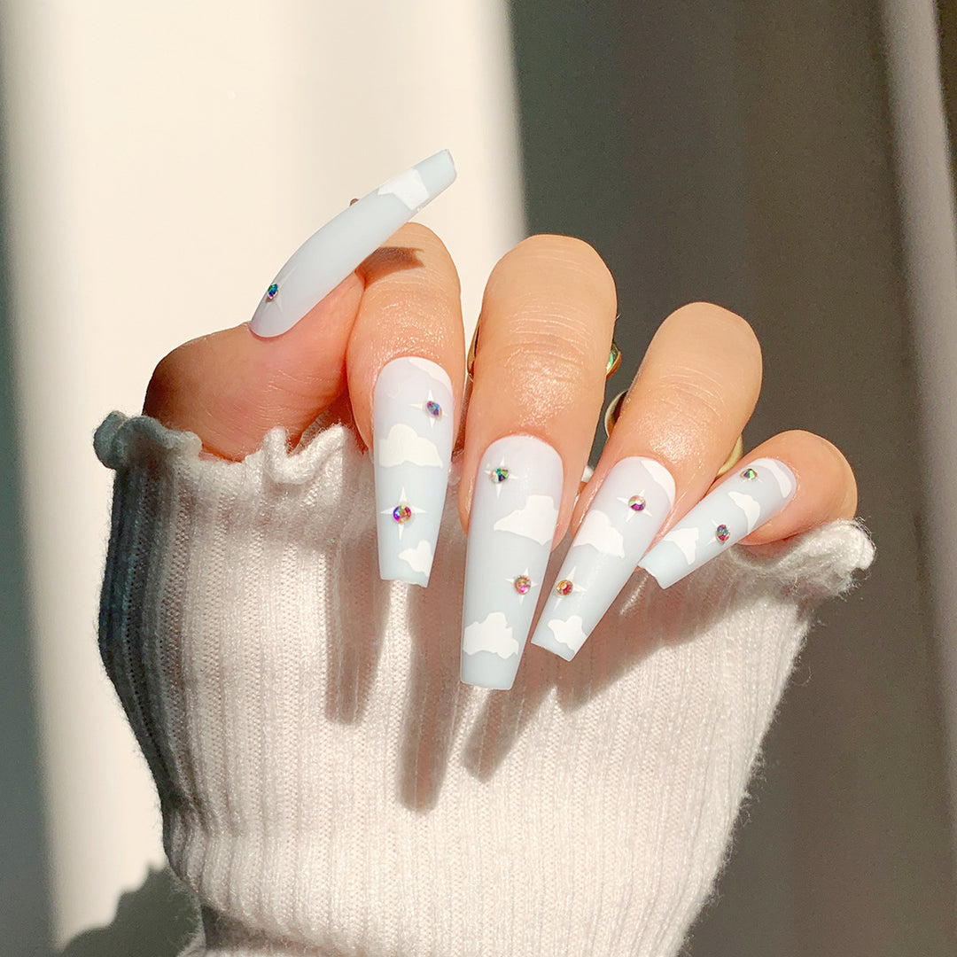 Creative nail art in cloud design with glitter accents Stornfield