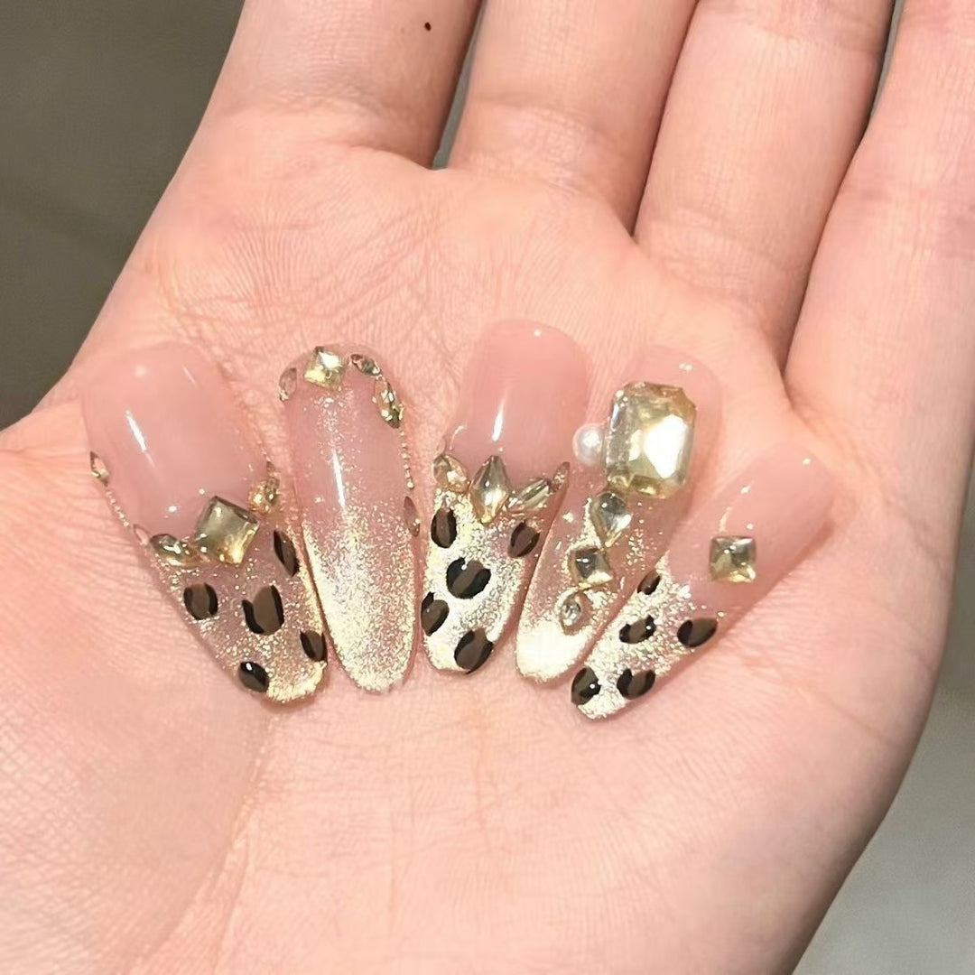 Glamorous artificial nails with elegant glitter accents and leopard details Stornfield