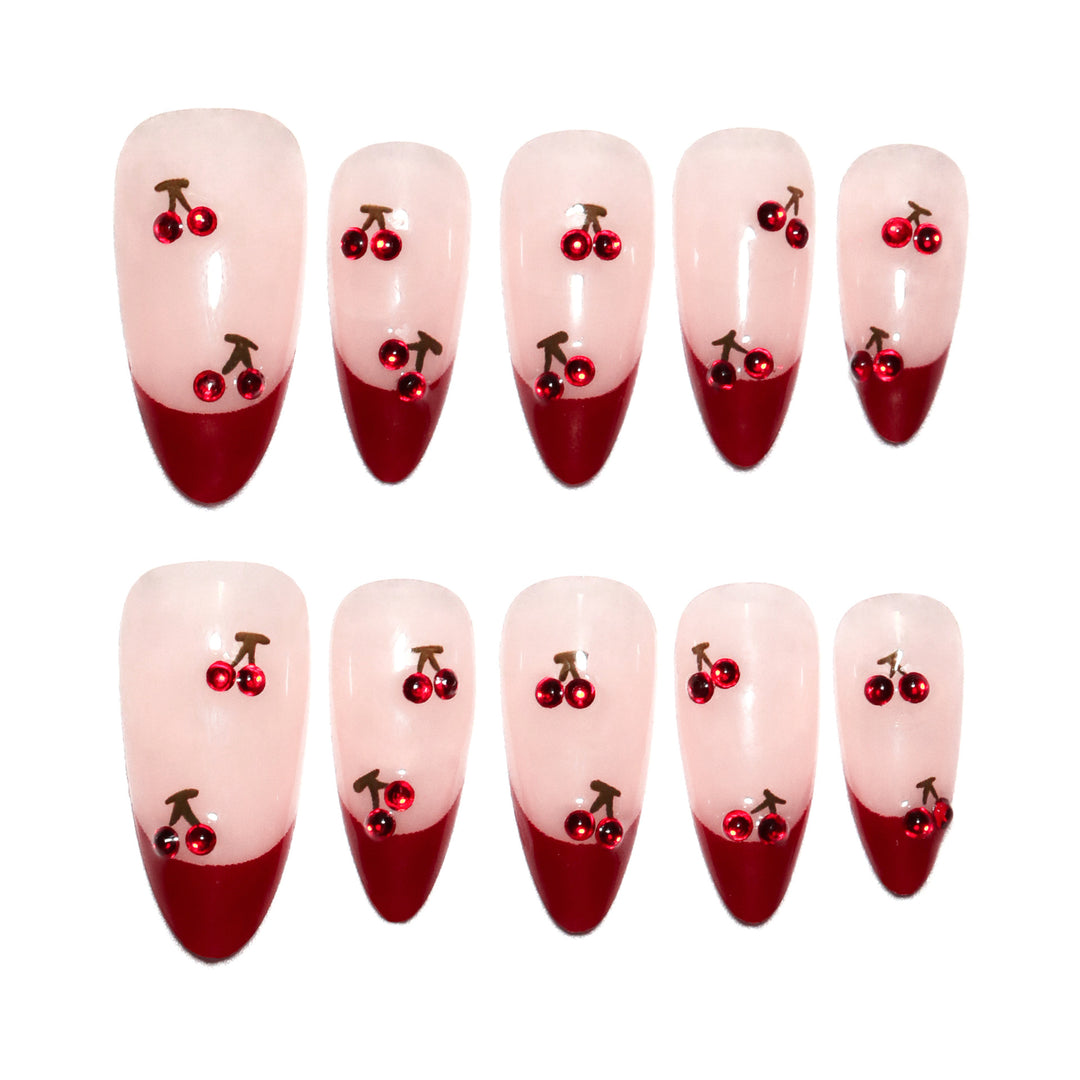 Artful stiletto nails with cherry motifs and glitter accents Stornfield