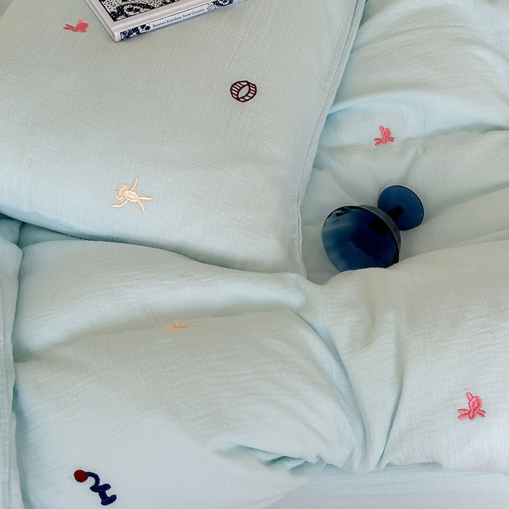 Bedding set made of cotton muslin with subtle embroidery patterns and extra-soft quilted texture