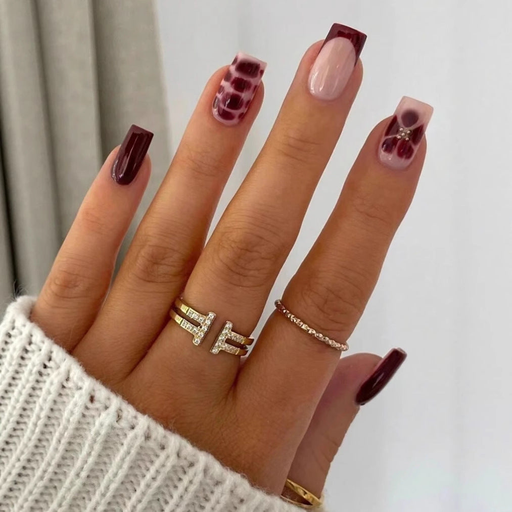 Artificial nail set with elegant geometric designs and accentuating rhinestone details Stornfield