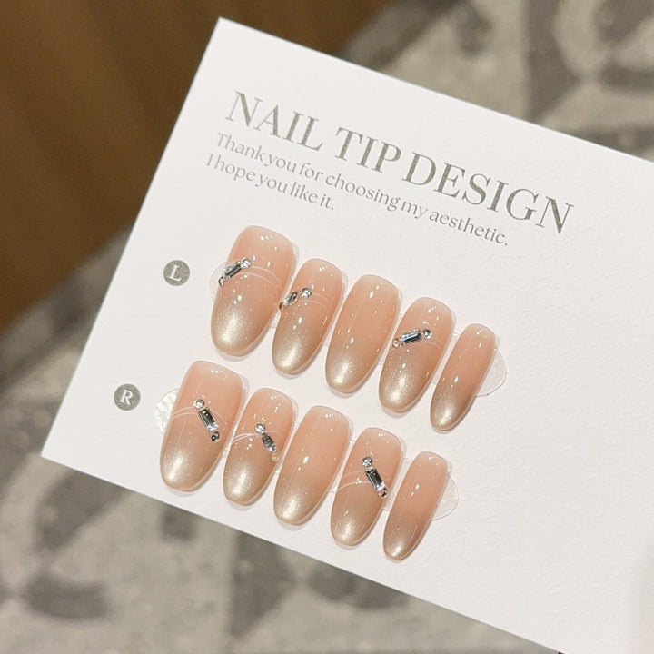 Artificial nail tips with elegant gradient color and rhinestone accents Stornfield