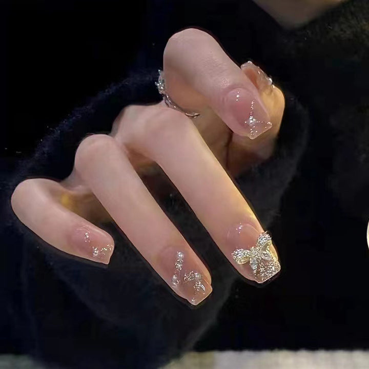 Artificial nails in an elegant design with 3D butterflies and glitter accents Stornfield