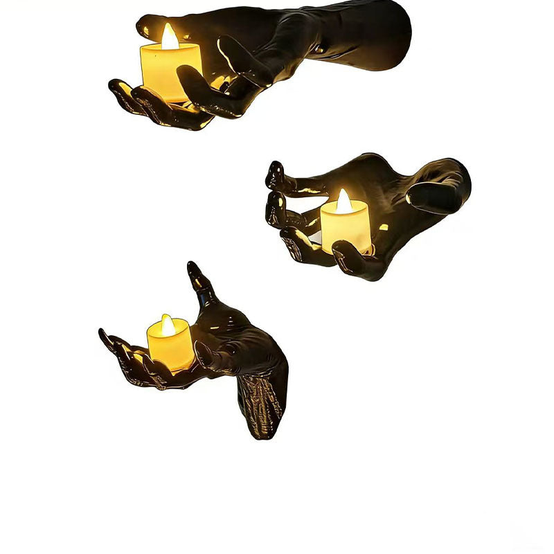 Wall candle holder in realistically shaped hand made of resin