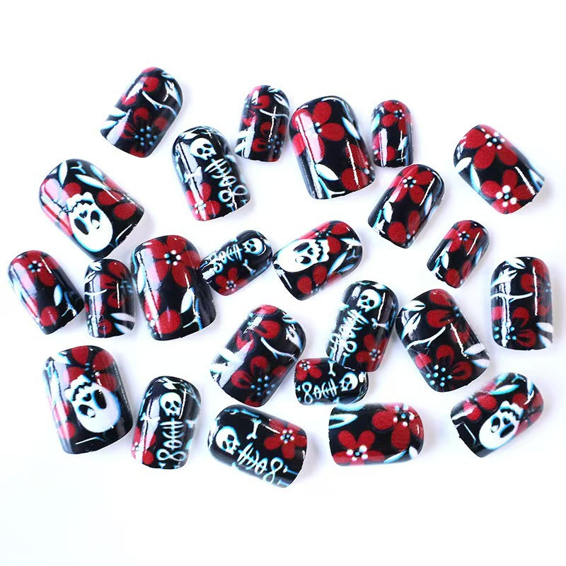 Artificial nail set with creepy skull design and floral accents Stornfield