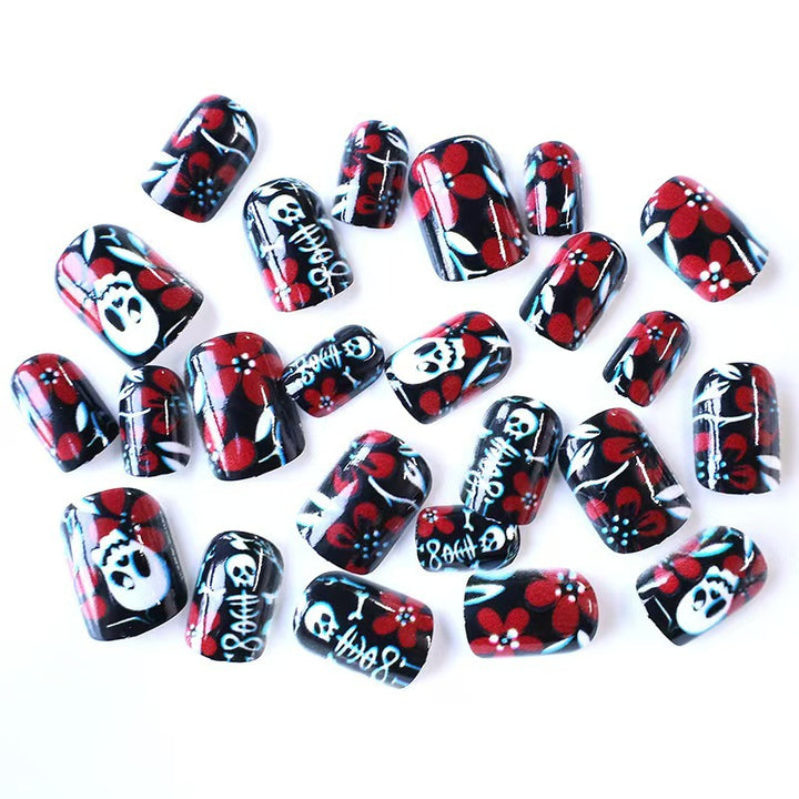 Artificial nail set with creepy skull design and floral accents Stornfield