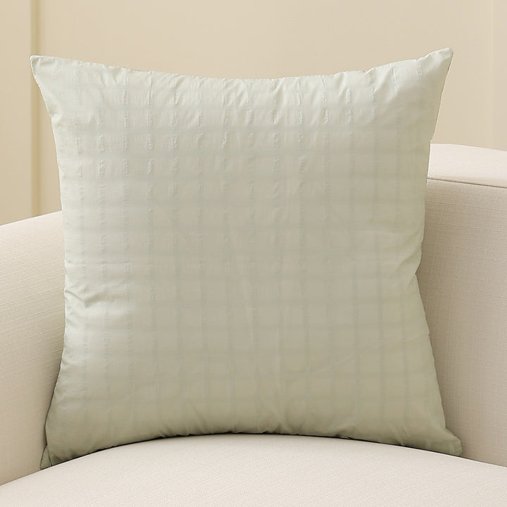 Square decorative cushion with delicate mother-of-pearl look and fine micro tuft structure