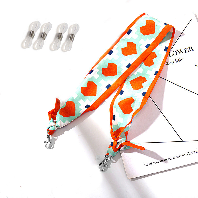 Fashionable fabric mask holder with floral motifs Stornfield