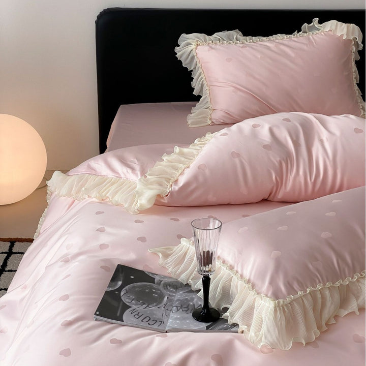 Elegant reversible bedding with romantic ruffle trim and subtle polka dot relief