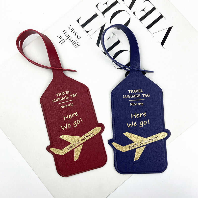 premium leather travel luggage ID tag with embossed airplane motif and adjustable strap Stornfield
