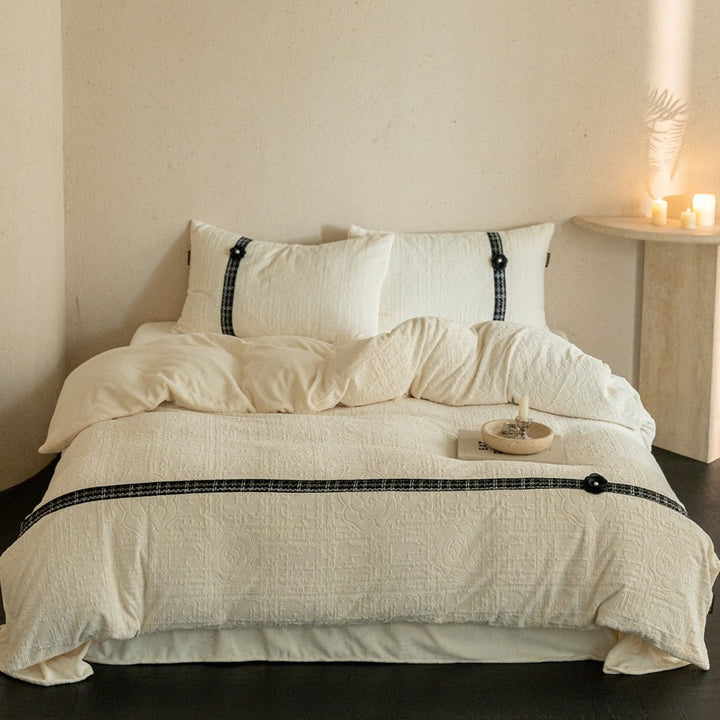 Quilted bedding set with decorative contrast ribbon and button closure