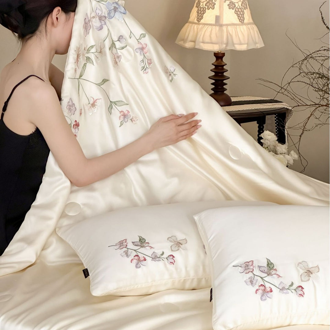 Luxurious bed linen set made of cotton satin with tonal floral embroidery and hotel closure