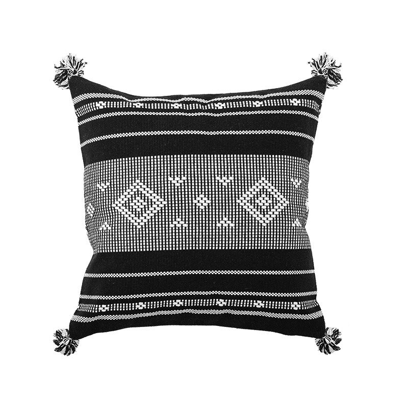 Square woven decorative cushion cover in tribal jacquard with pom-pom corners