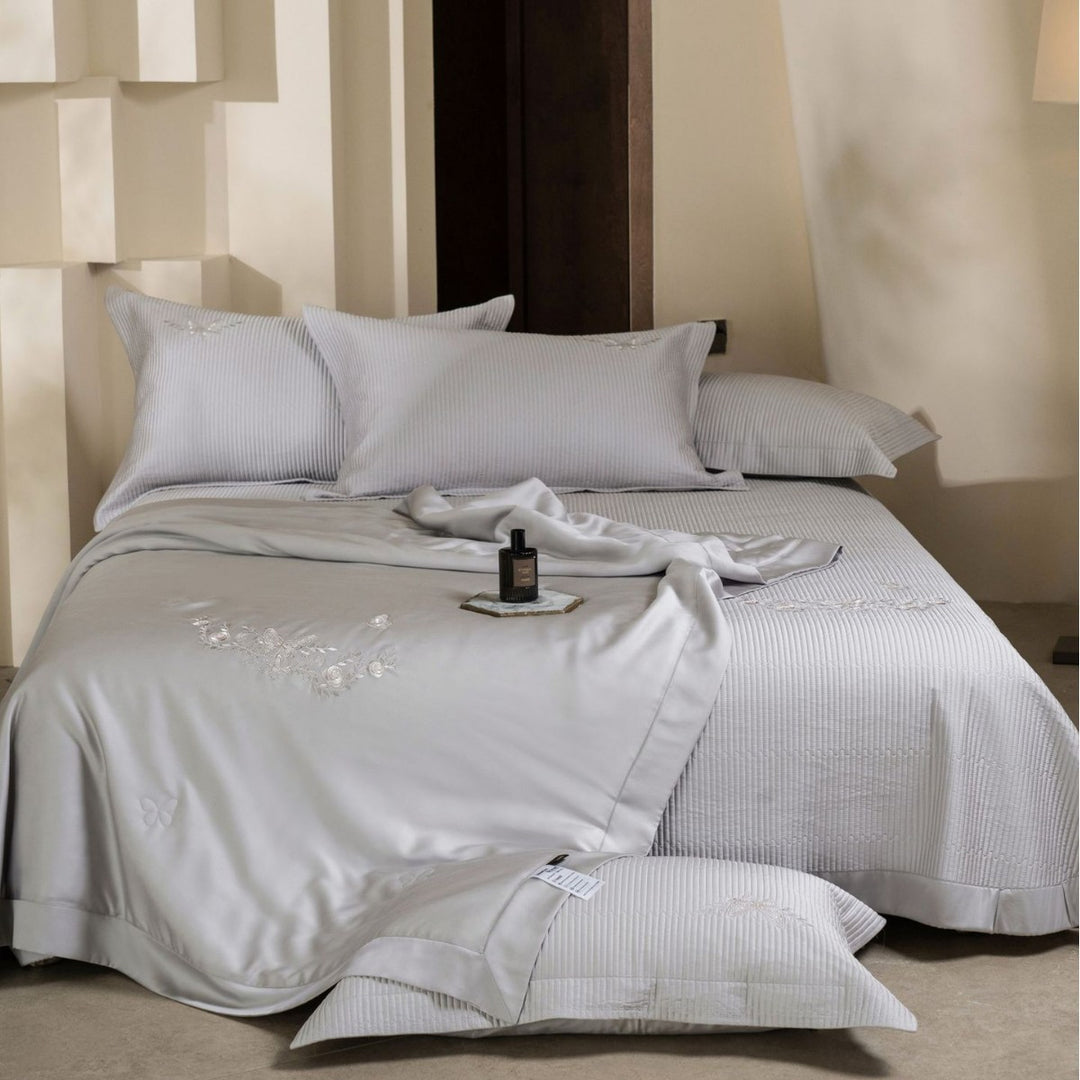 Luxurious cotton satin bedding set with quilted bedspread and floral embroidery