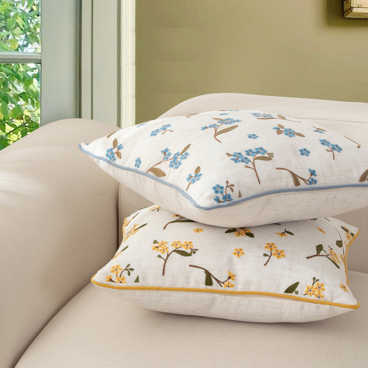 Decorative embroidered cushion cover made of linen blend with floral yellow flower appliqué and piping Stornfield