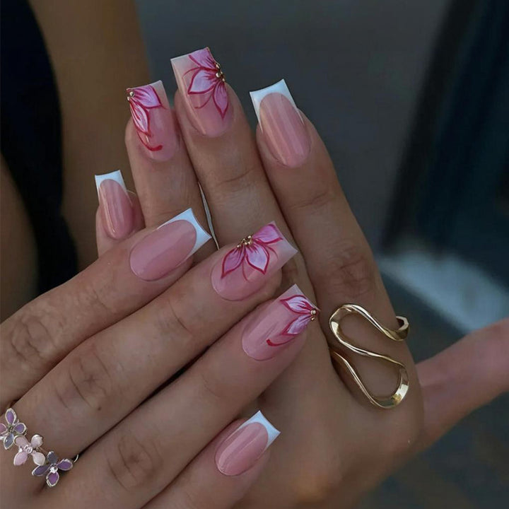 Artificial nail set with elegant flower designs and glitter accents Stornfield