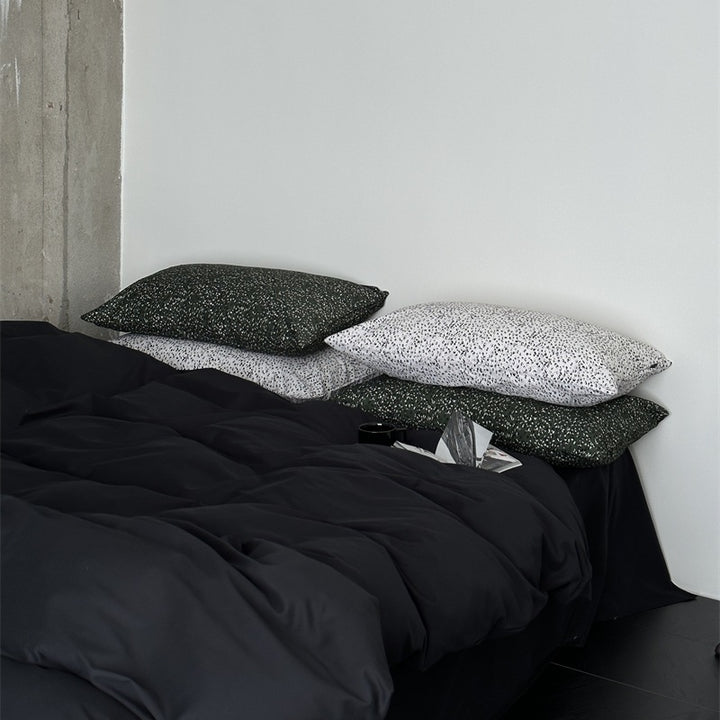 Modern satin bedding set with quilted look and patterned pillowcases