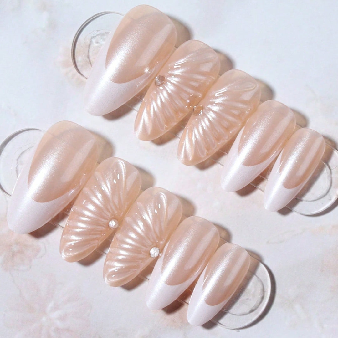 Artificial nail set with elegant shell pattern and glitter accents Stornfield