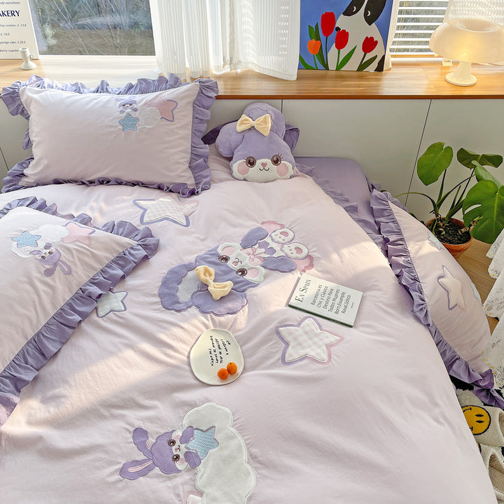 Children's bedding set with plush appliqués, ruffled flounces, and embroidery