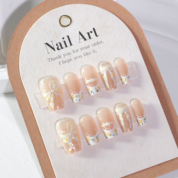 Artful Nail Extensions with Floral Design and Bow Accents Stornfield