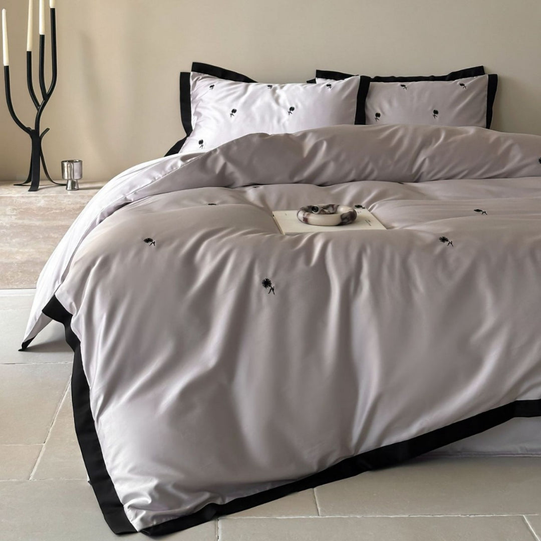 Elegant satin bed set with fine cherry embroidery and contrasting piping
