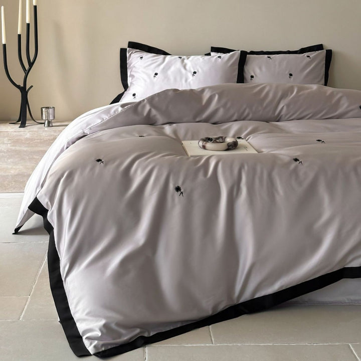Elegant satin bed set with fine cherry embroidery and contrasting piping