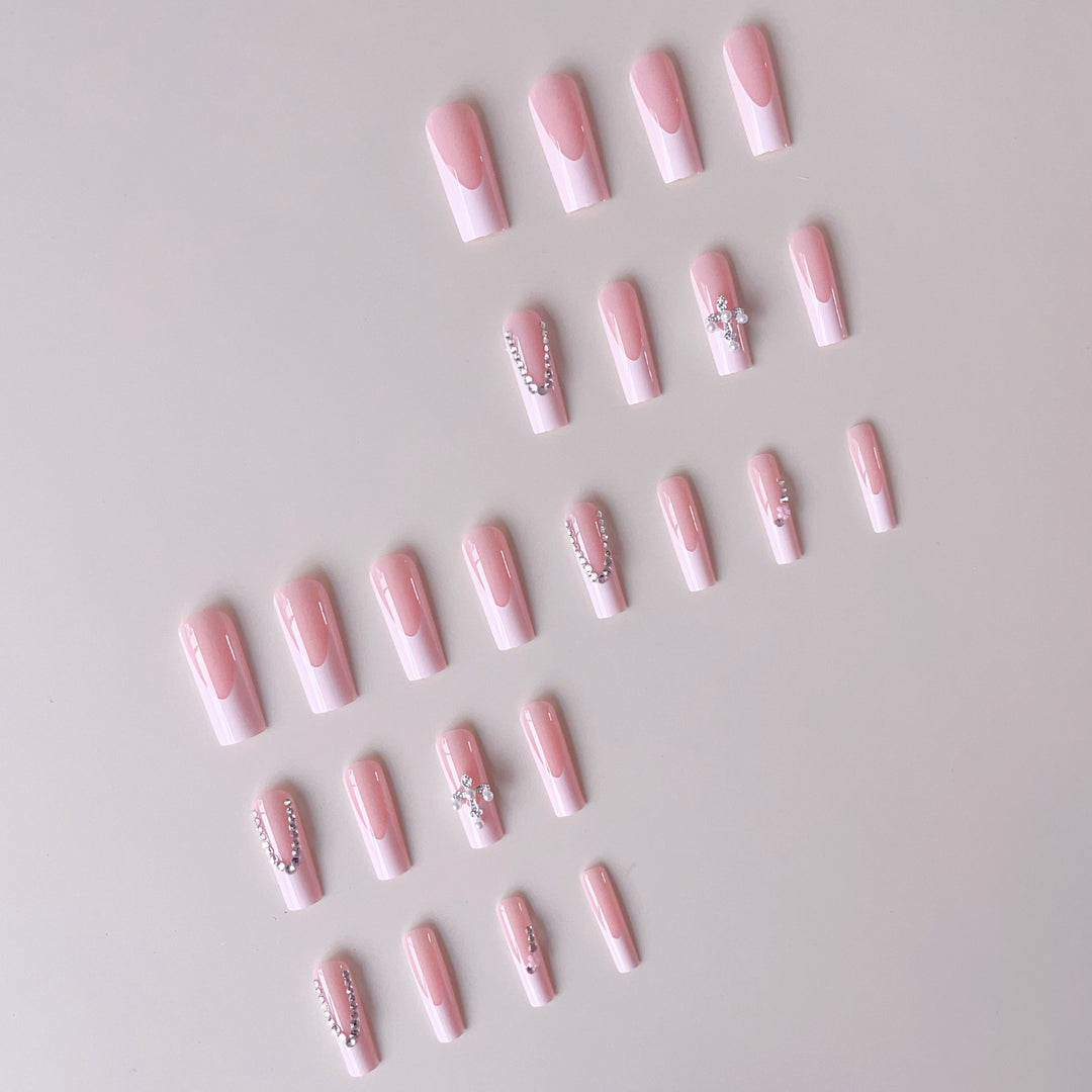Acrylic nail set with glamorous rhinestone decorations and elegant French tips Stornfield