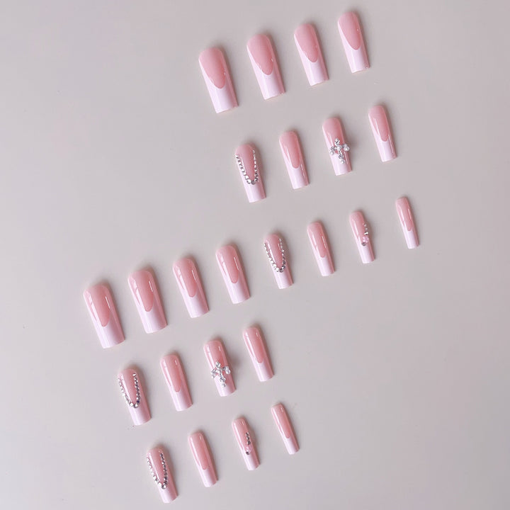 Acrylic nail set with glamorous rhinestone decorations and elegant French tips Stornfield