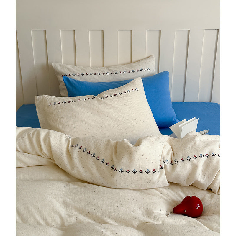 Cotton gauze bedding set with delicate border embroidery and mottled nep structure