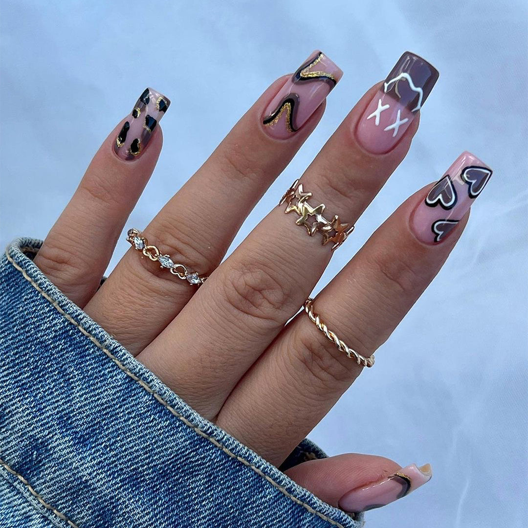 Artful nail extensions in elegant design with gold accents Stornfield