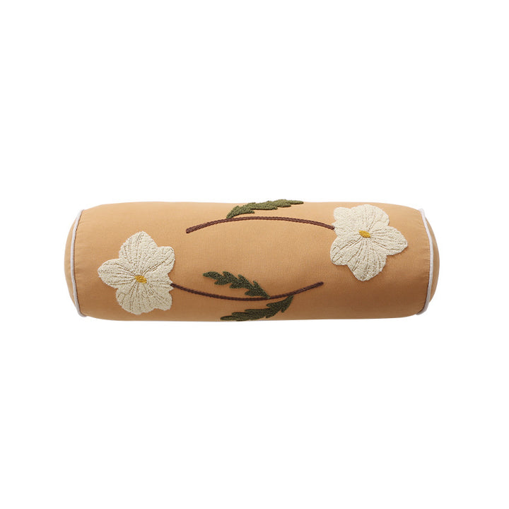Bolster pillow with hand-stitched floral motif and decorative piping