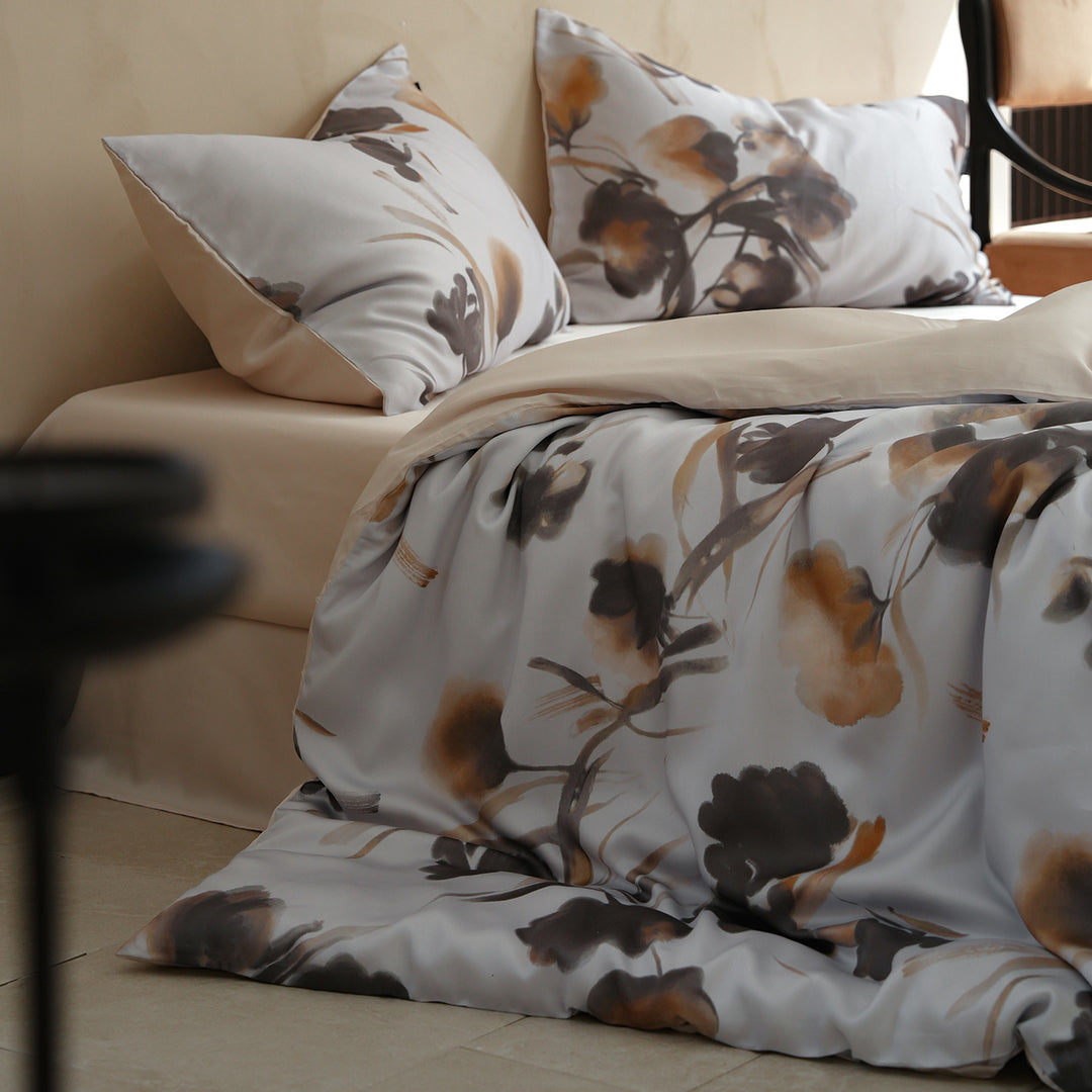 Satin bed linen set with ruffled bed skirt and floral printed pillowcases