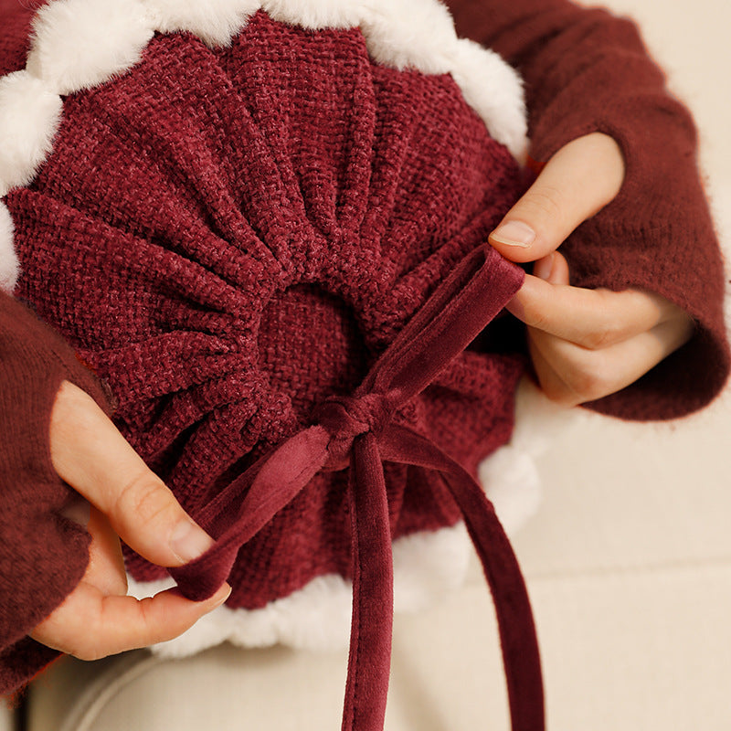 Cylindrical lumbar and neck pillow with velvety chenille surface and crocheted trim Stornfield