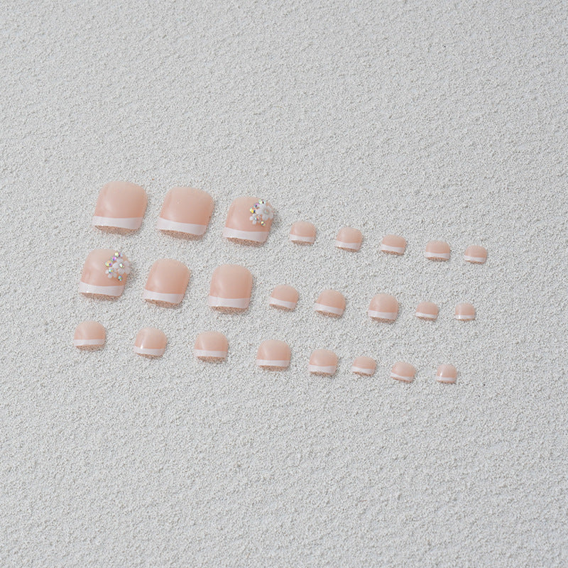 Artificial nail set with elegant French tip design and sparkling accents Stornfield