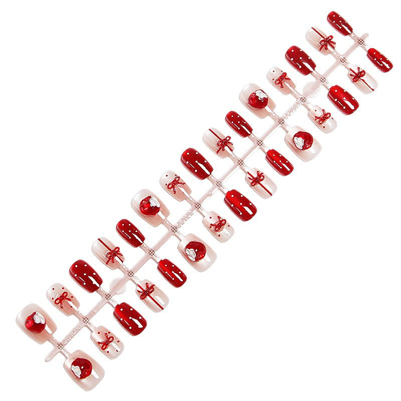 Artificial nail set with festive gift design and elegant glitter accents Stornfield