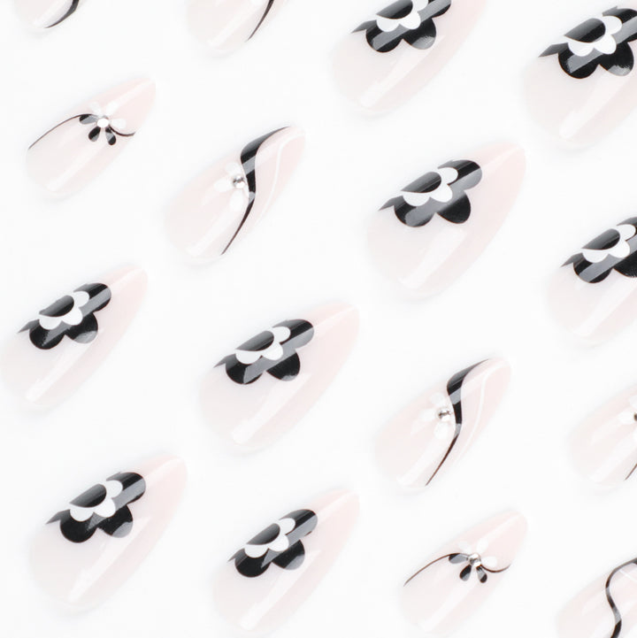 Artistic nail extensions with floral accents and glitter accents Stornfield