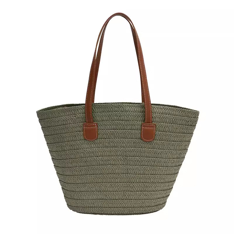Stylish beach bag made of woven natural material with leather handles Stornfield