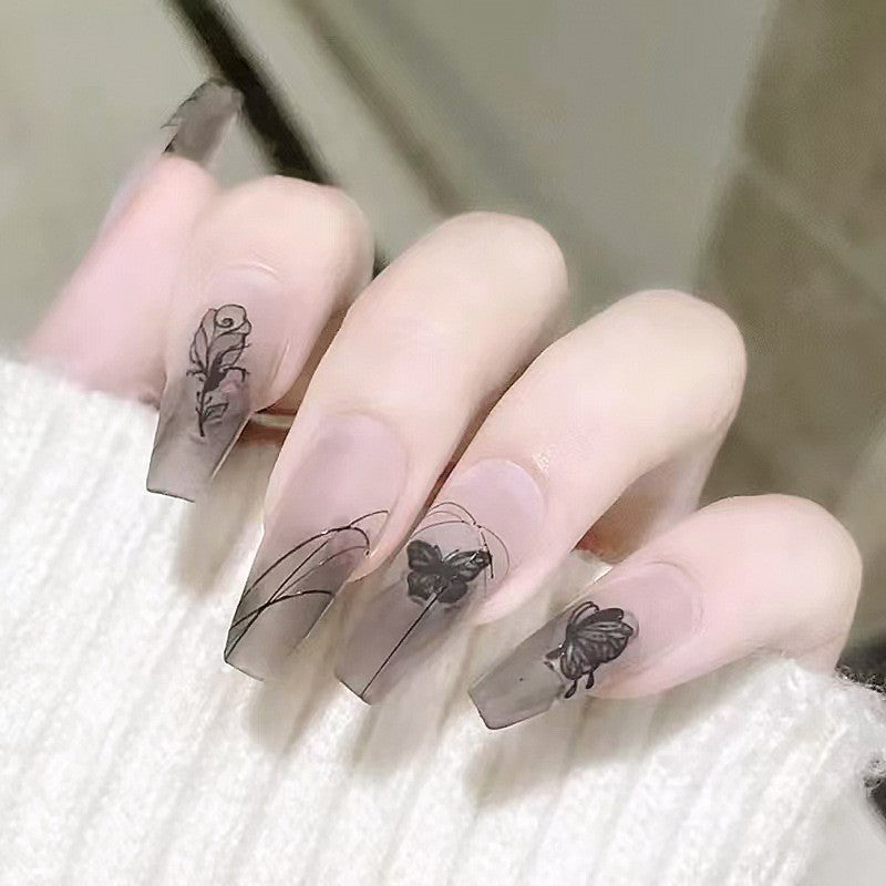 Artificial nail set with elegant flower design and delicate butterfly motifs Stornfield