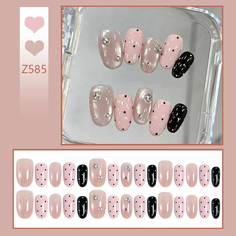 Acrylic nail set with glamorous rhinestone accents and modern dots Stornfield