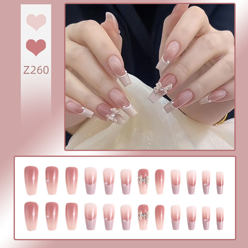 Artificial nail set with elegant ombre design and delicate bow embellishments Stornfield