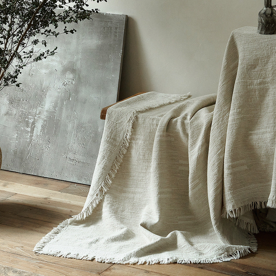 Massive wooden bed with upright slatted headboard and natural linen bedding