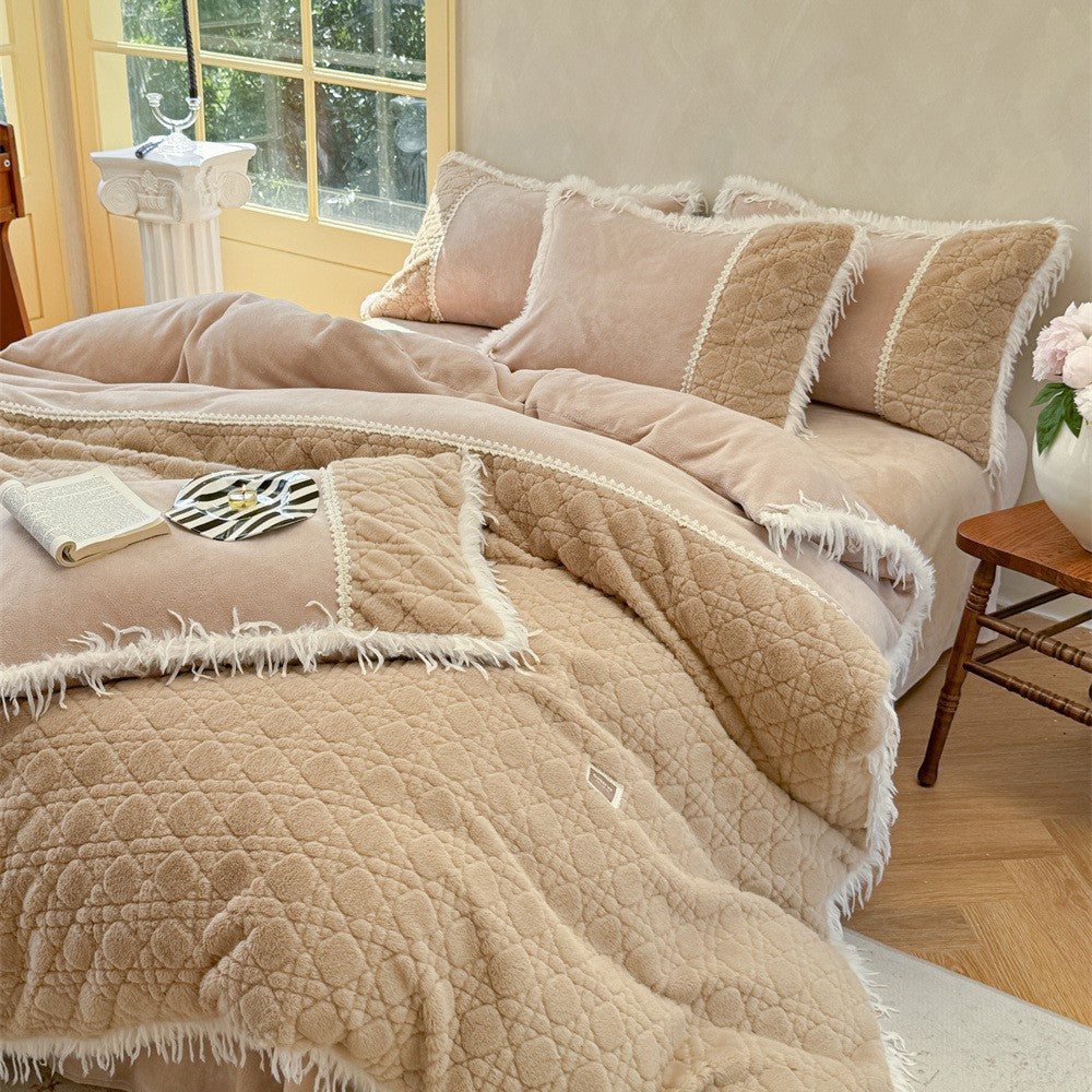 Quilted bedding with fringes and decorative pillows
