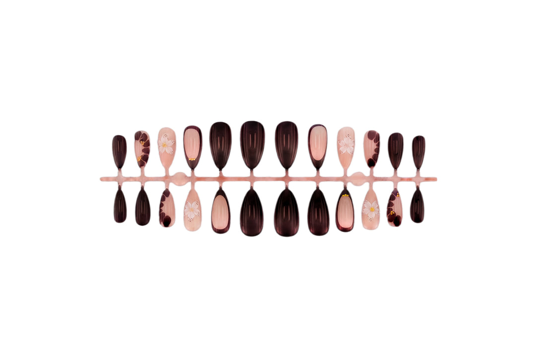 Acrylic nail set with elegant floral patterns and glamour accents Stornfield