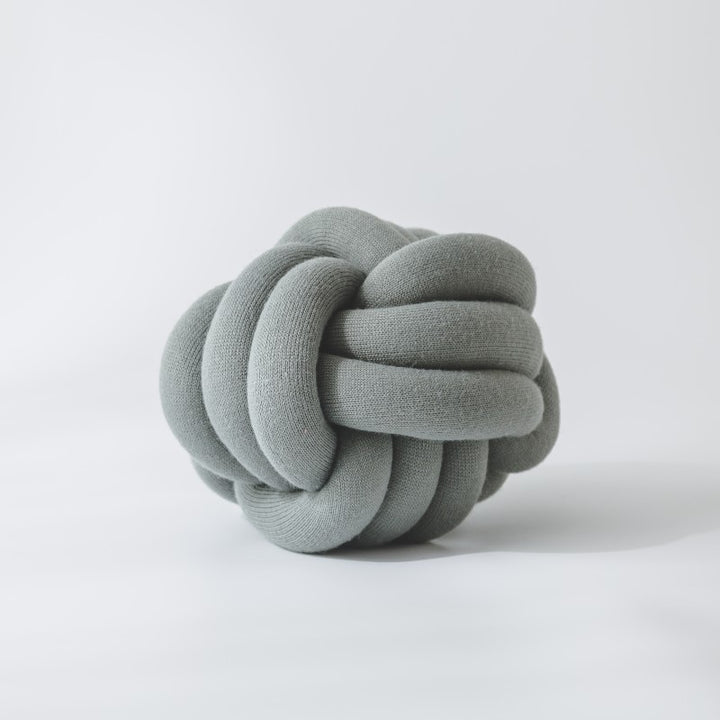 Decorative knitted knot cushion as a decorative pillow made of soft jersey