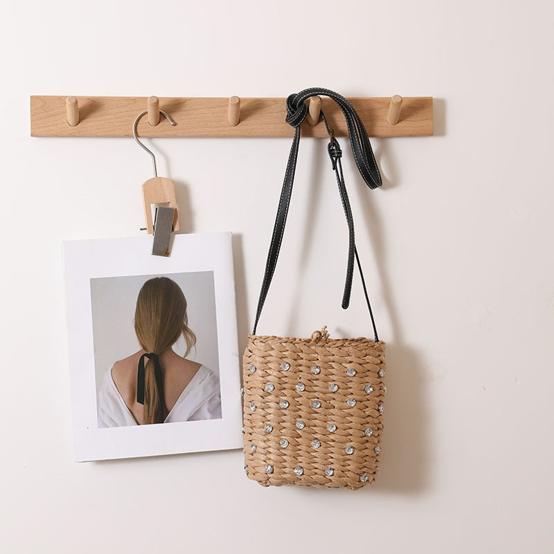 Bag made of woven natural material with sparkling appliqués Stornfield