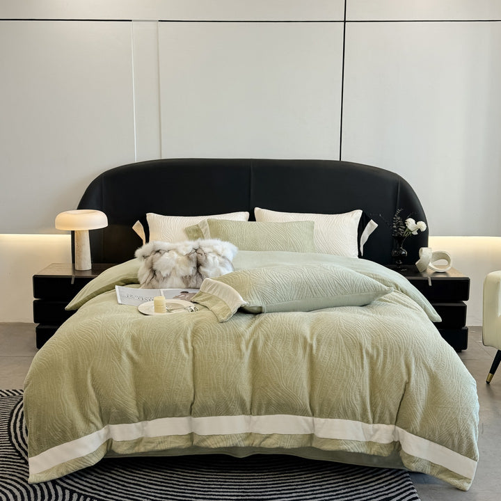 Quilted bedding set made of cotton blend with raised leaf texture and contrasting border